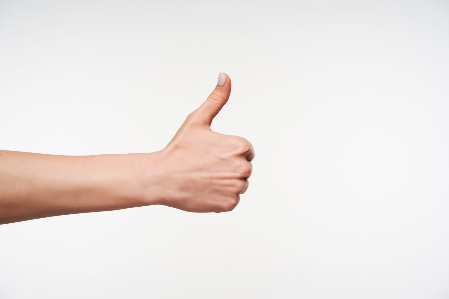 close-up-young-woman-with-white-manicure-raising-hand