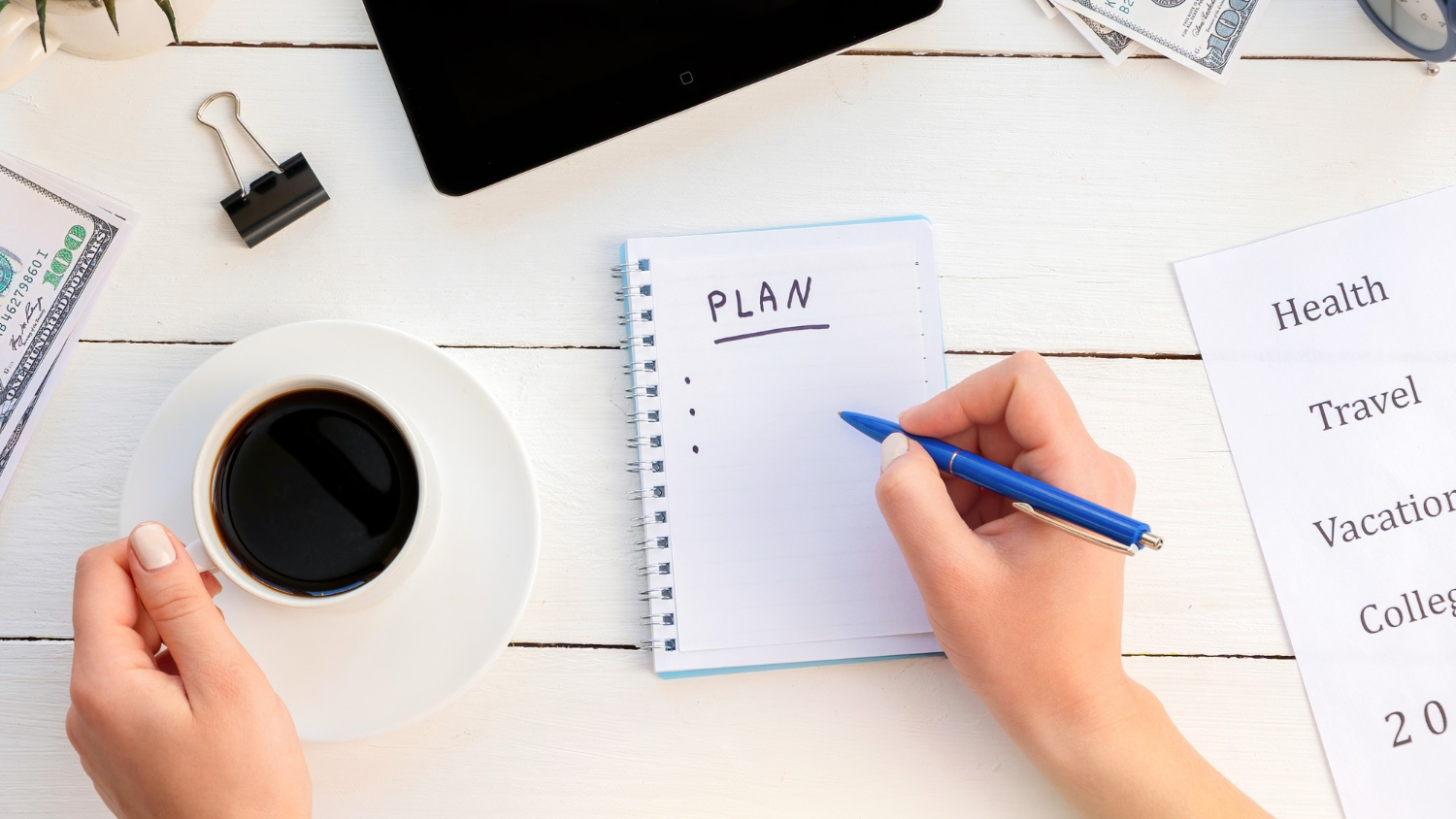 female-hands-writing-plan-notepad-holding-coffee-tablet-money-wooden-background